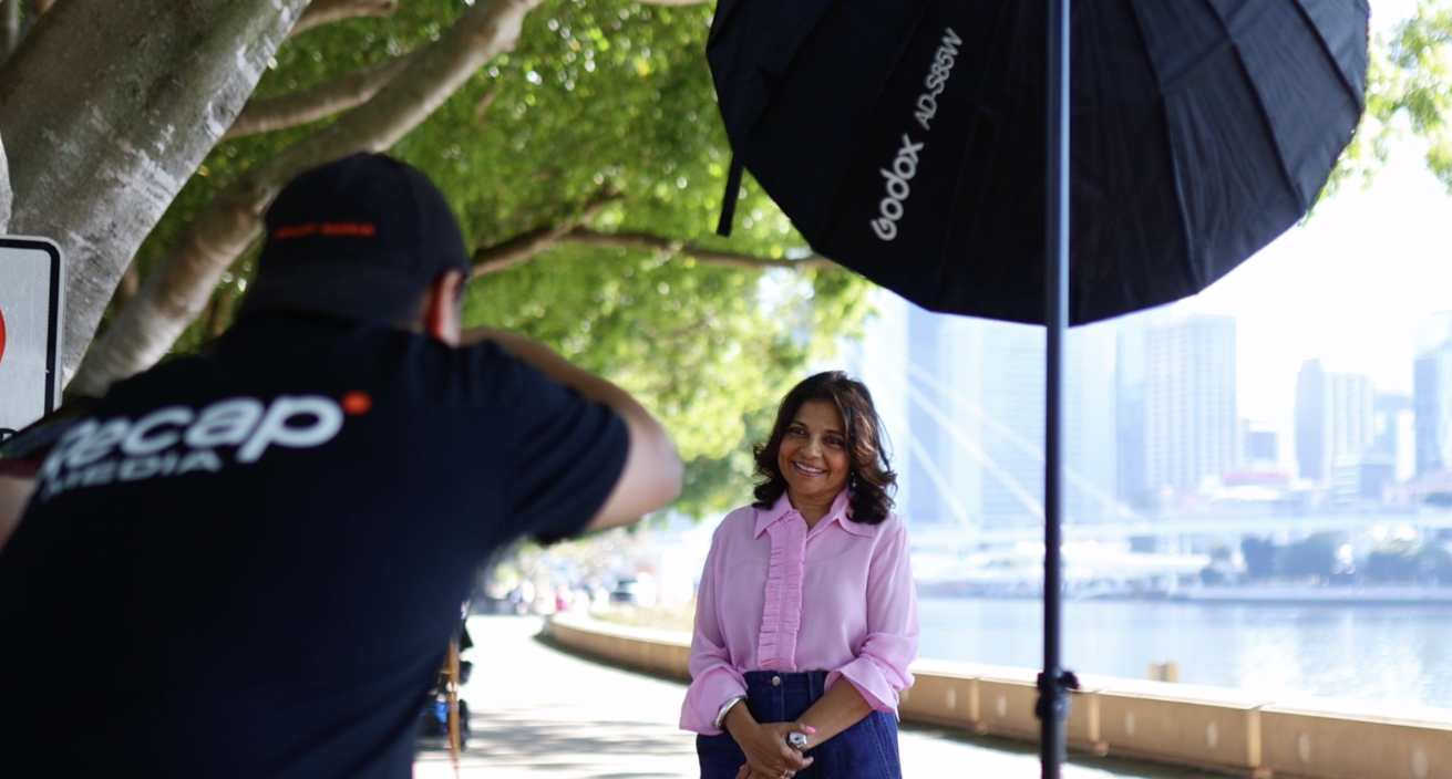 Recap Media photographer shooting a headshot of a woman by the Brisbane River